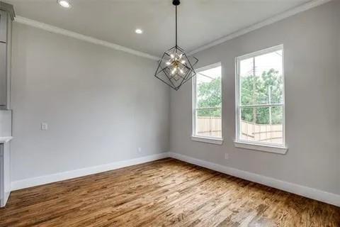 1702 Seevers Avenue Dallas, TX 75216 - Photo 12 of 24 a view of an empty room with wooden floor and a window