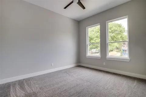 1702 Seevers Avenue Dallas, TX 75216 - Photo 18 of 24 an empty room with a window and a ceiling fan