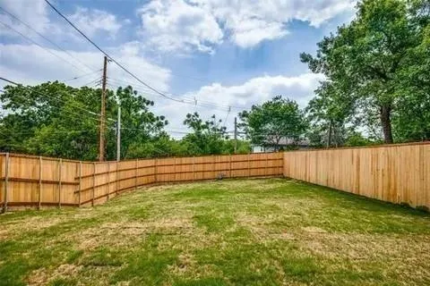 a view of a yard with a fence