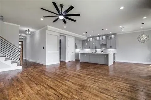 a view of a kitchen with a sink and a large window