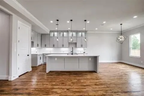 a kitchen with kitchen island a sink stainless steel appliances and cabinets