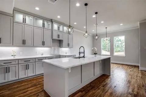 1702 Seevers Avenue Dallas, TX 75216 - Photo 5 of 24 a kitchen with stainless steel appliances granite countertop a sink a stove and a wooden floors