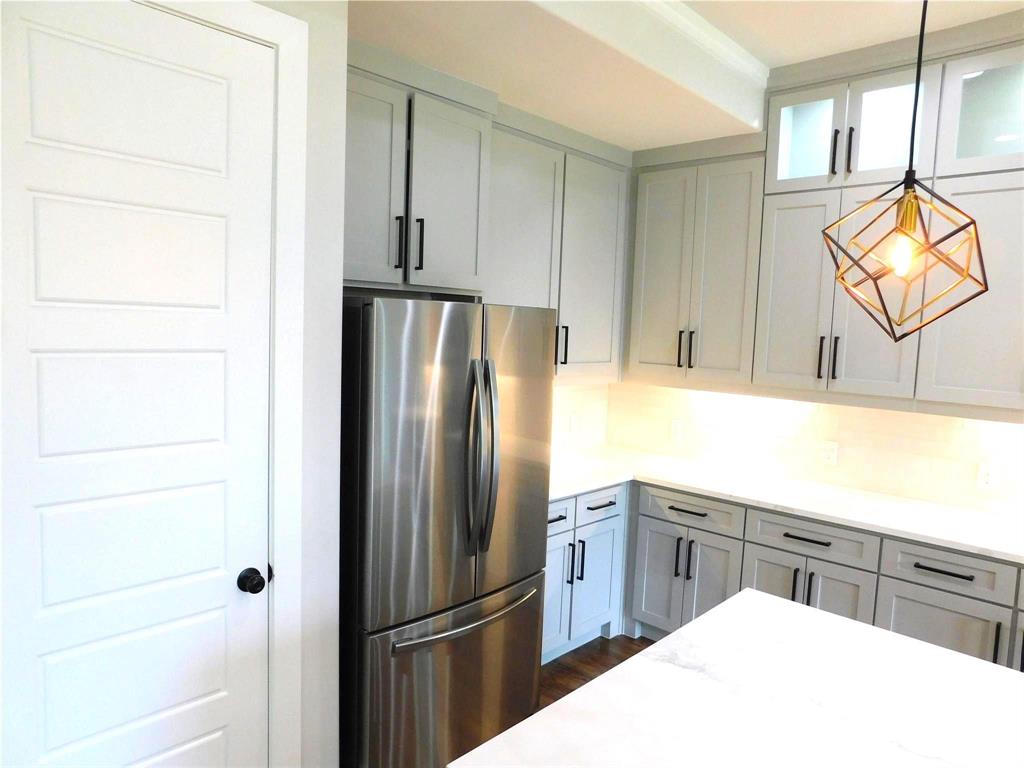 1702 Seevers Avenue Dallas, TX 75216 - Photo 7 of 24 a kitchen with a refrigerator a sink dishwasher and cabinets