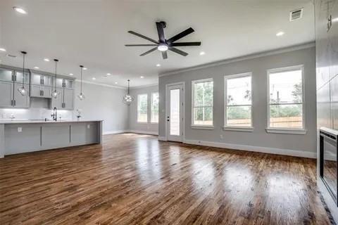 1702 Seevers Avenue Dallas, TX 75216 - Photo 9 of 24 a view of an empty room with wooden floor and a window