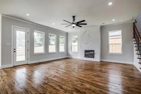 1702 Seevers Avenue Dallas, TX 75216 - Photo 10 of 24 a view of an empty room with wooden floor and a window