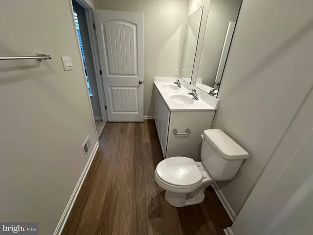 a white toilet sitting next to a bathroom sink
