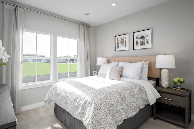 a bedroom with bed and a window