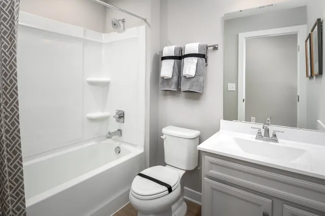 a bathroom with a white toilet sitting next to a bathroom sink and a bathtub