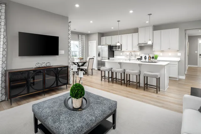 a large kitchen with a table and chairs in it