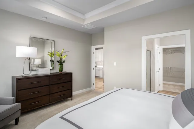 a bedroom with a bed and a lamp on table