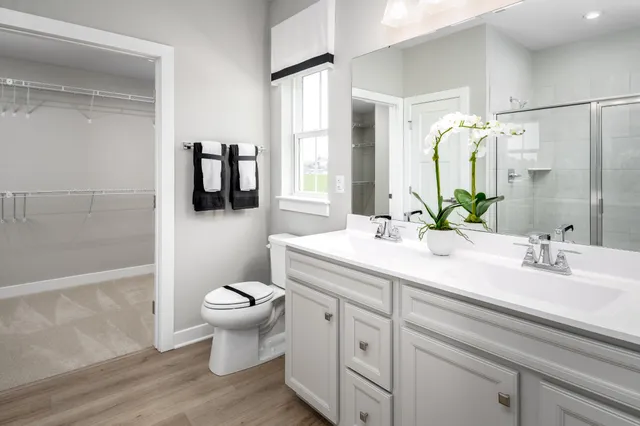a bathroom with a sink toilet and shower