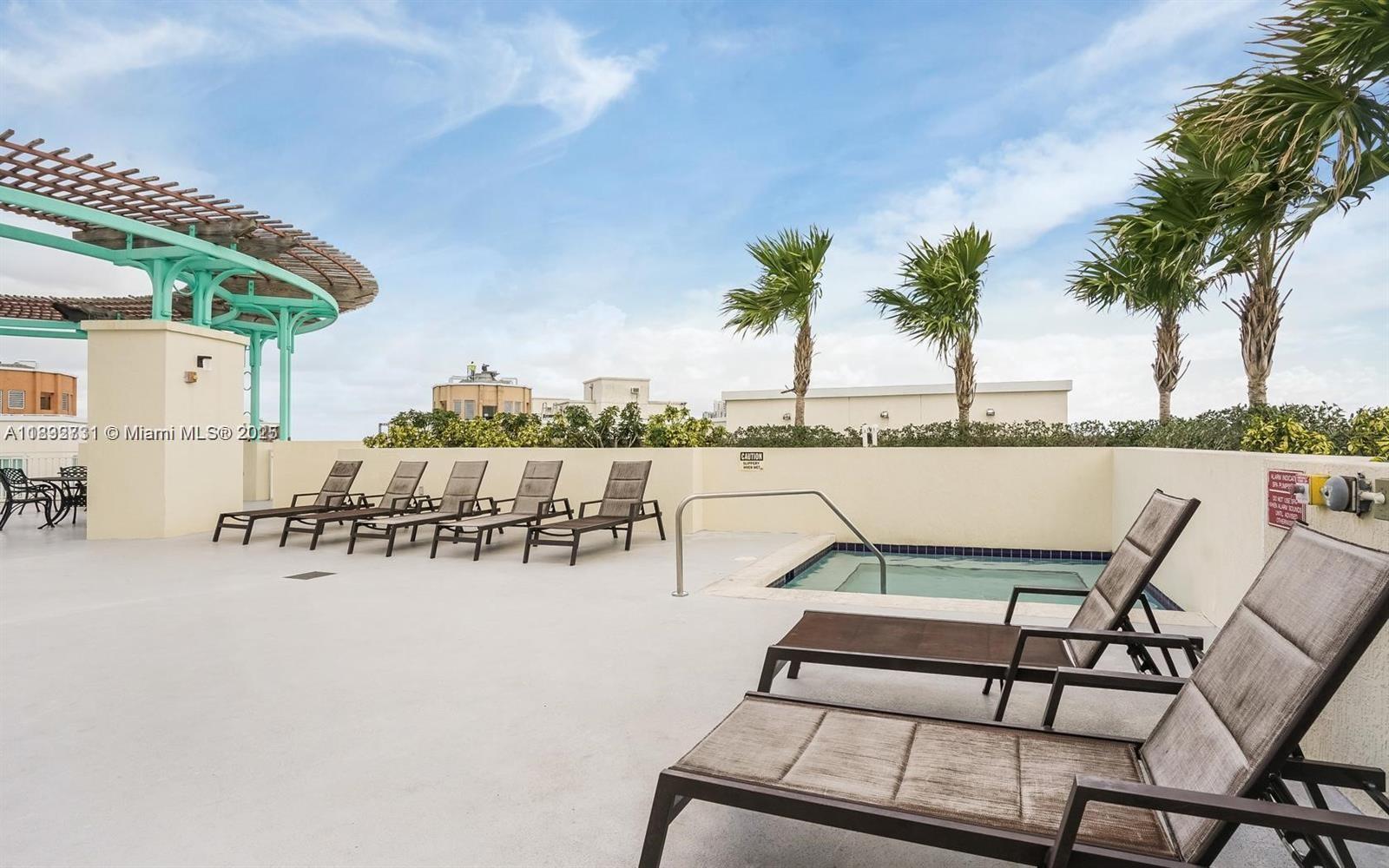 7270 Southwest 88th Street, Unit B502 Miami, FL 33156 - Photo 18 of 20 a view of a swimming pool with a table and chairs