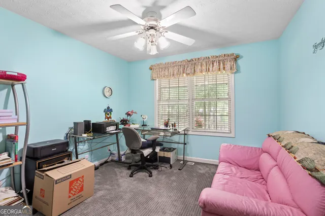 a bathroom with a granite countertop sink mirror vanity and toilet