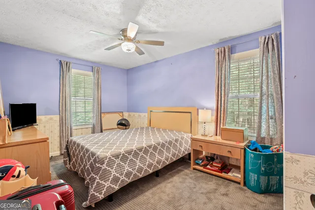 a bedroom with a bed and wooden furniture