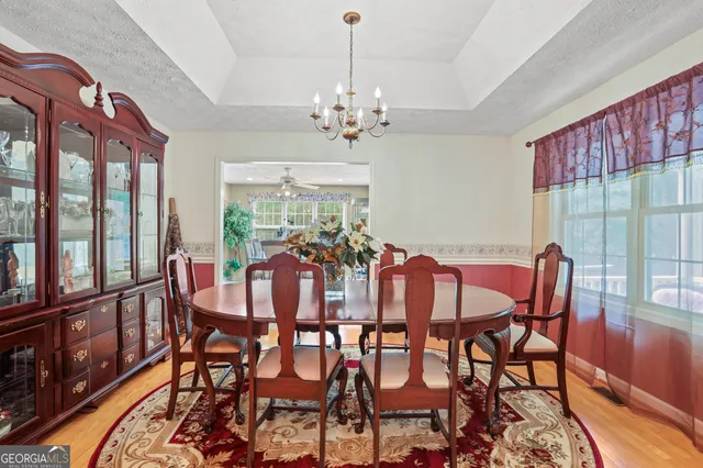 a view of a dining room with furniture window and outside view
