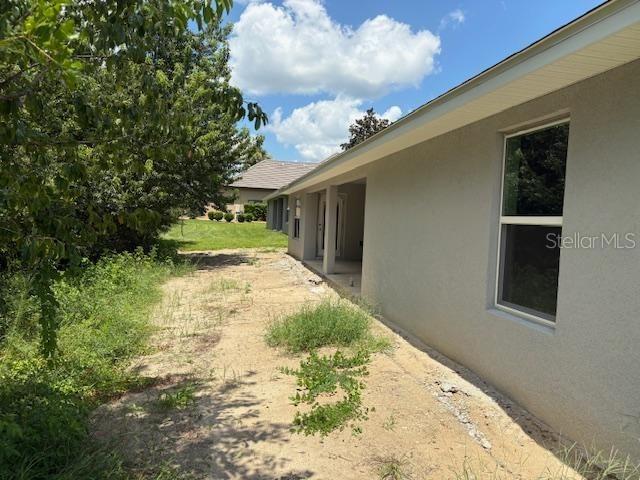 6716 Southwest 179th Ave Road Dunnellon, FL 34432 - Photo 8 of 17 a view of white house with a yard