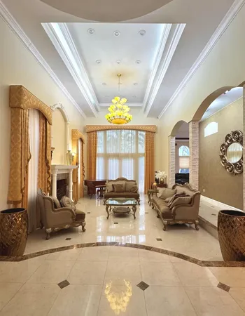 a living room with fireplace furniture and a large window