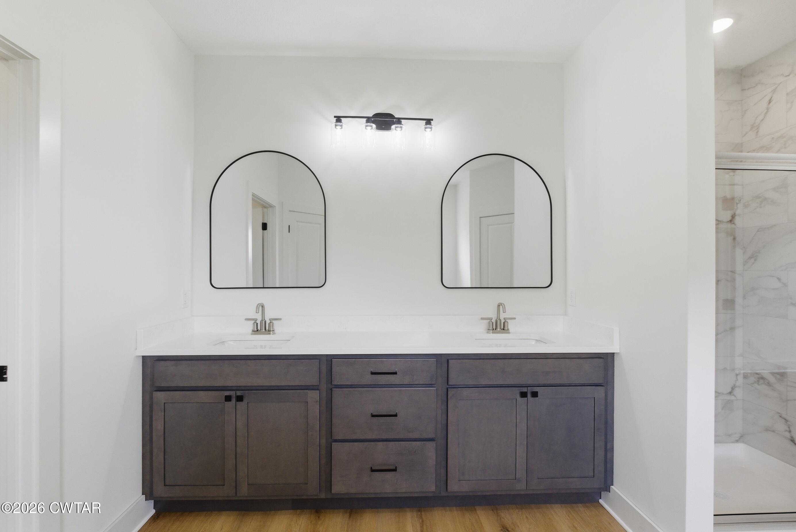 179 Daybreak Loop Medina, TN 38355 - Photo 18 of 32 a bathroom with 2 sink and a mirror