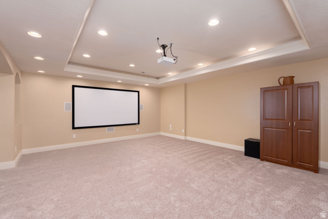 687 South 2080th Street East Springville, UT 84663 - Photo 30 of 149 Spacious entertainment room featuring a large projection screen, recessed ceiling lights, and a tray ceiling with crown molding