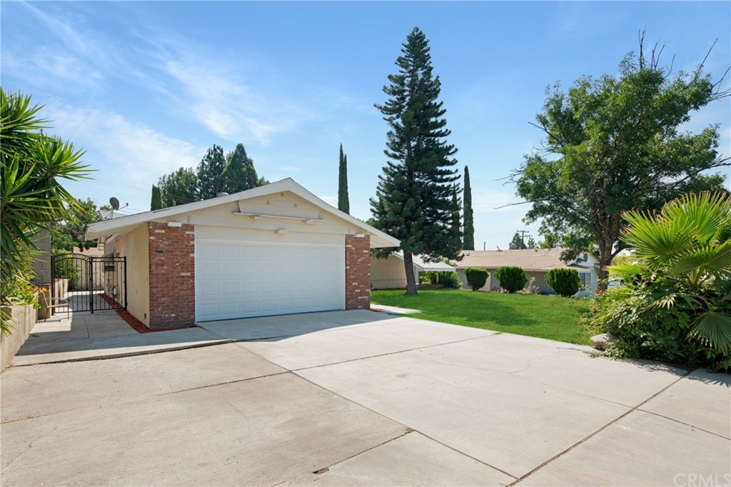 6265 Halstead Avenue Rancho Cucamonga, CA 91737 - Photo 1 of 1 a view of a house with a yard and garage