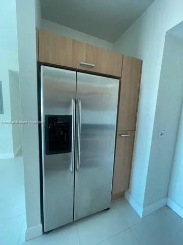 a bathroom with a glass door shower and vanity