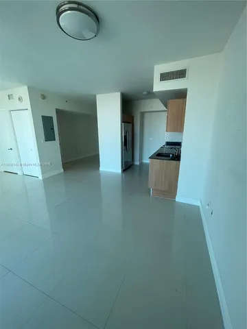 an empty room with large windows