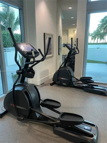 a view of a hardwood floor and a car park in the back