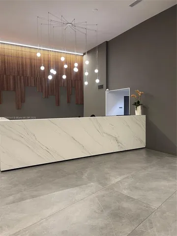 a living room with couches and chandelier