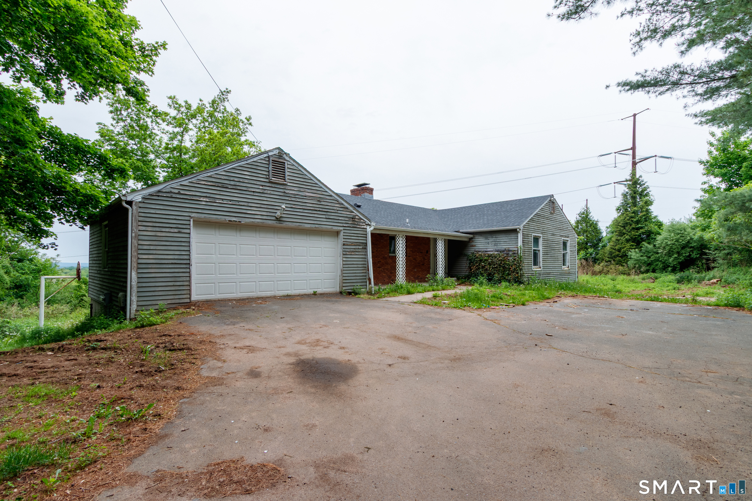 63 High Hill Road Wallingford, CT 06492 - Photo 2 of 34 a front view of a house with a yard and garage