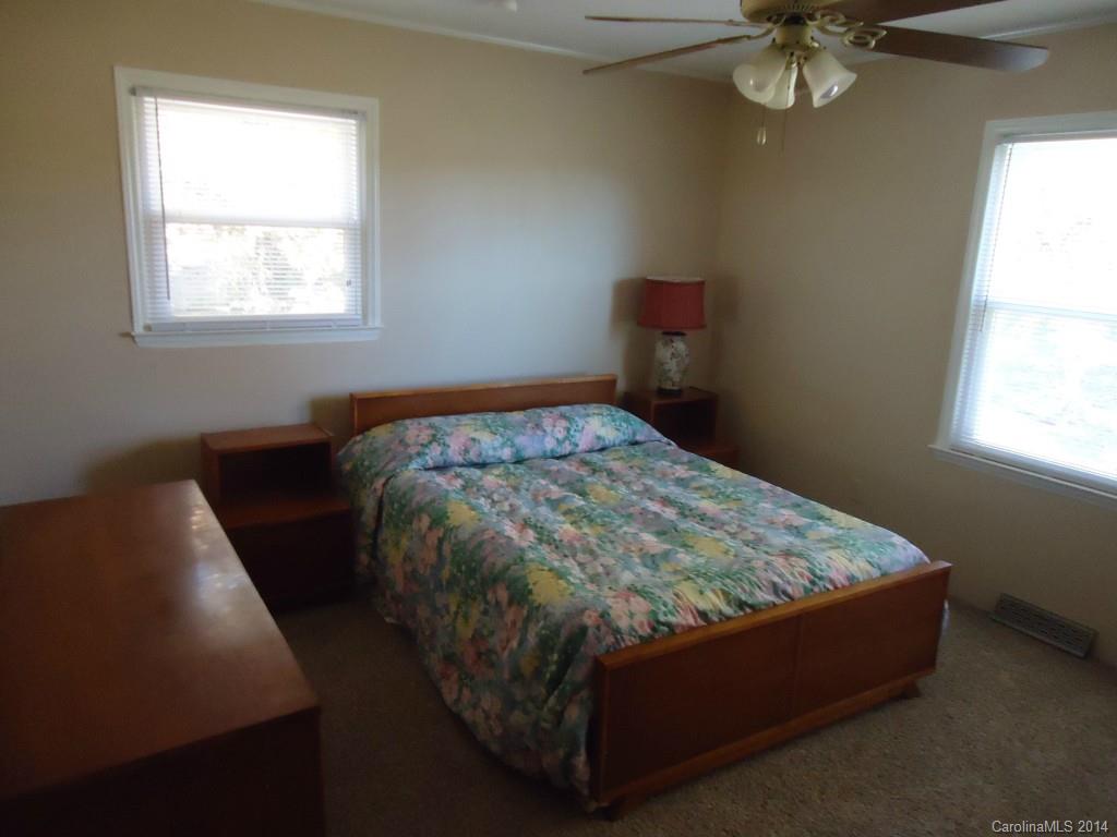 405 Absher Road Bessemer City, NC 28016 - Photo 12 of 15 a bed sitting in a bedroom next to a window