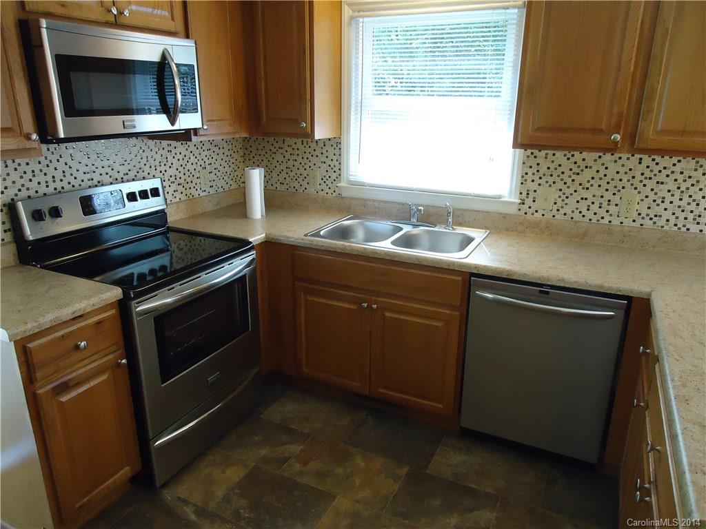 405 Absher Road Bessemer City, NC 28016 - Photo 4 of 15 a kitchen with a stove microwave and sink