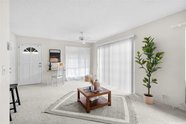 a living room with furniture and potted plants