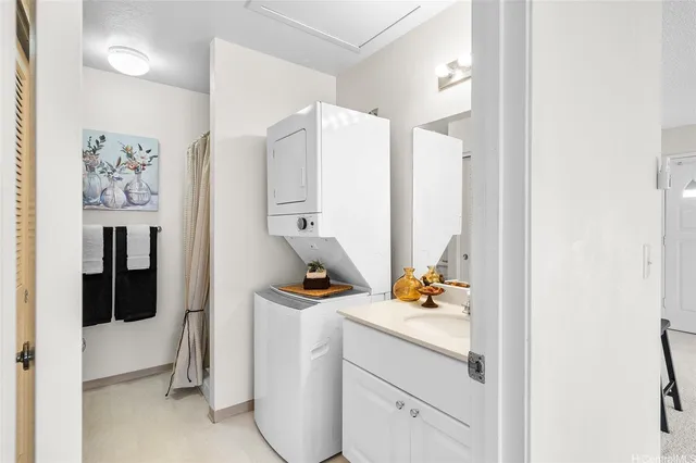 a room with a white bed and dresser