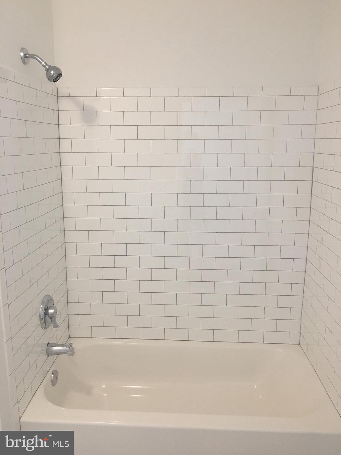 4733 Umbria Street, Unit C Philadelphia, PA 19127 - Photo 9 of 14 a bathroom with a bathtub