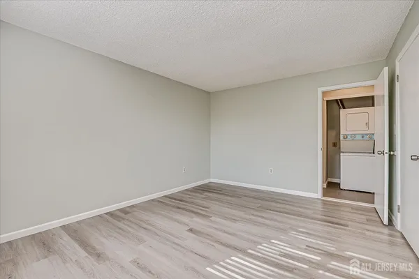 a view of room with wooden floor