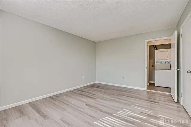a view of room with wooden floor