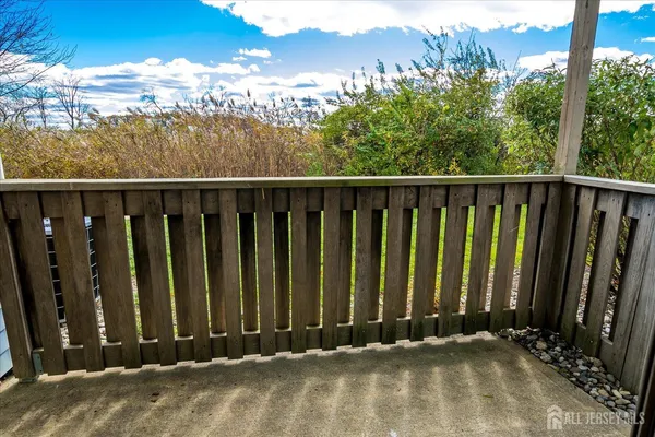 a view of a balcony with wooden fence
