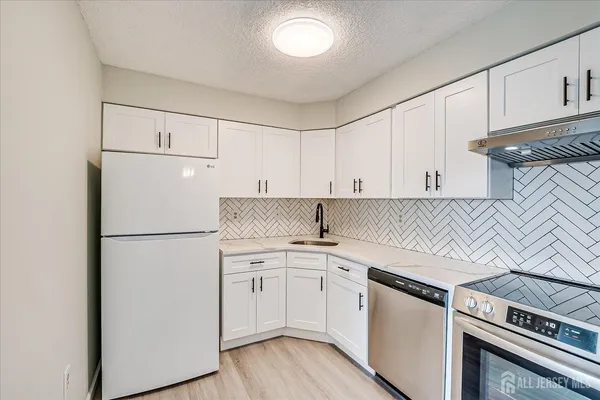 a kitchen with a white cabinets and white appliances
