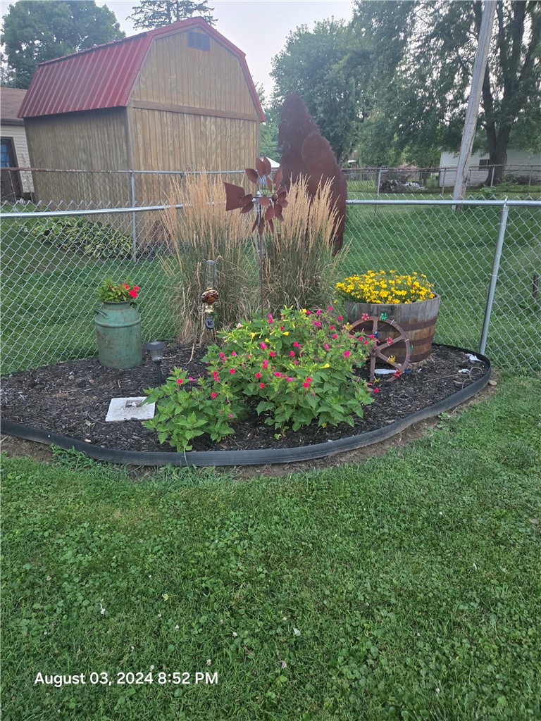 321 Liberty Street Eaton, OH 45320 - Photo 17 of 34 This lush yard features a charming garden bed and convenient storage shed.