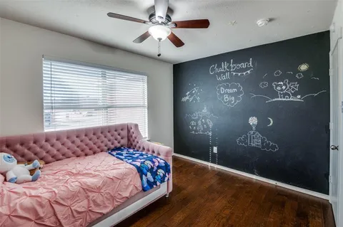 a bed sitting in a bedroom next to a window