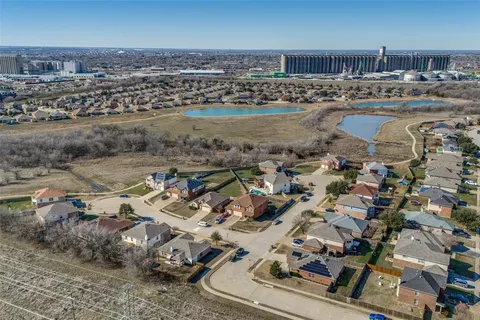 an aerial view of residential houses with outdoor space
