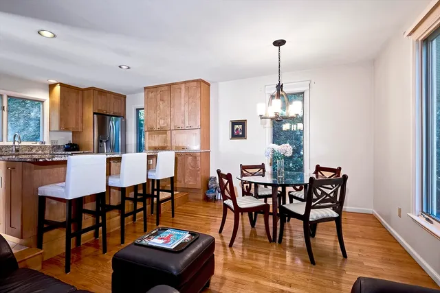 a view of a a dining room with furniture window and wooden floor