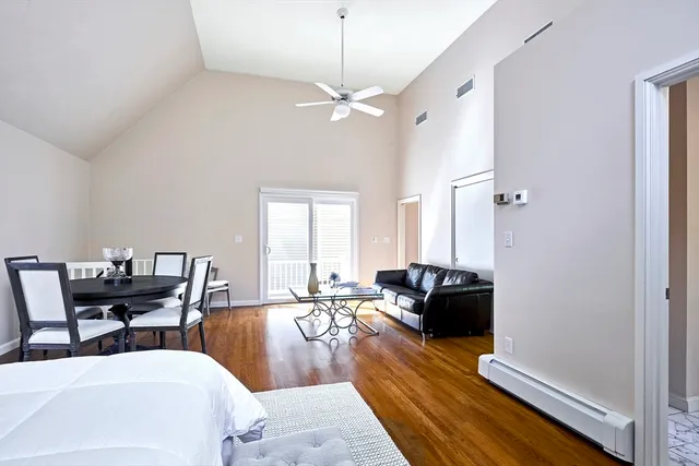 a living room with furniture a fireplace and a chandelier