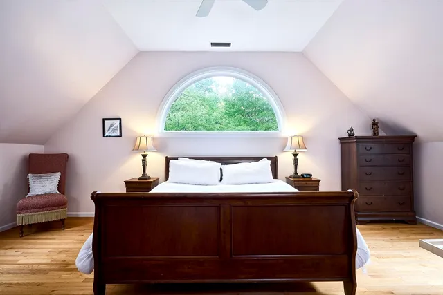 a bedroom with a bed and window