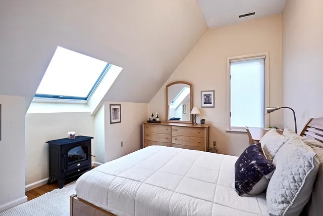 a bedroom with a large bed and a dresser