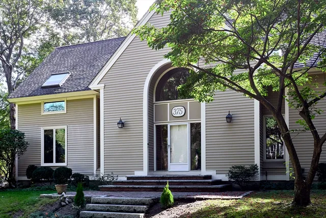 a front view of a house with garden