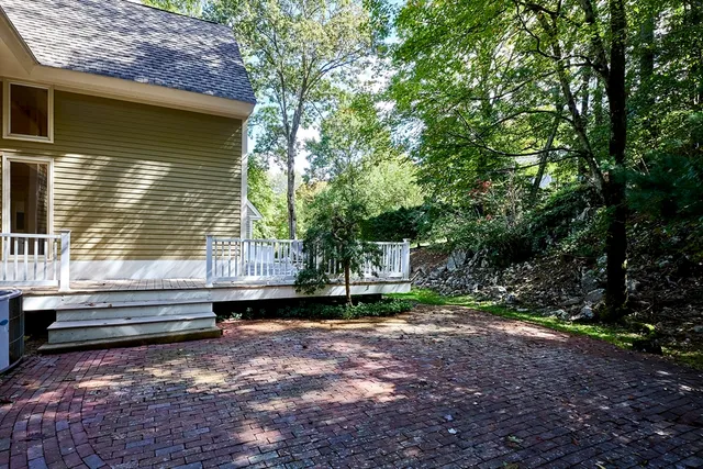 a back view of a house with backyard and trees