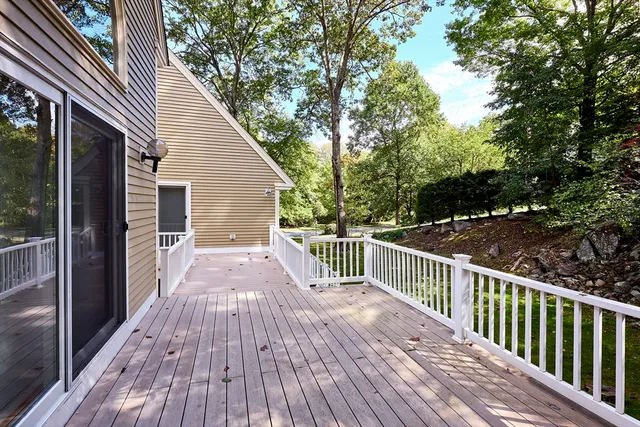 a view of a wooden deck and a yard