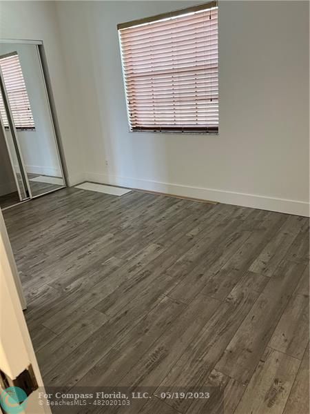 301 Southwest 158th Terrace, Unit 103 Pembroke Pines, FL 33027 - Photo 1 of 7 an empty room with wooden floor
