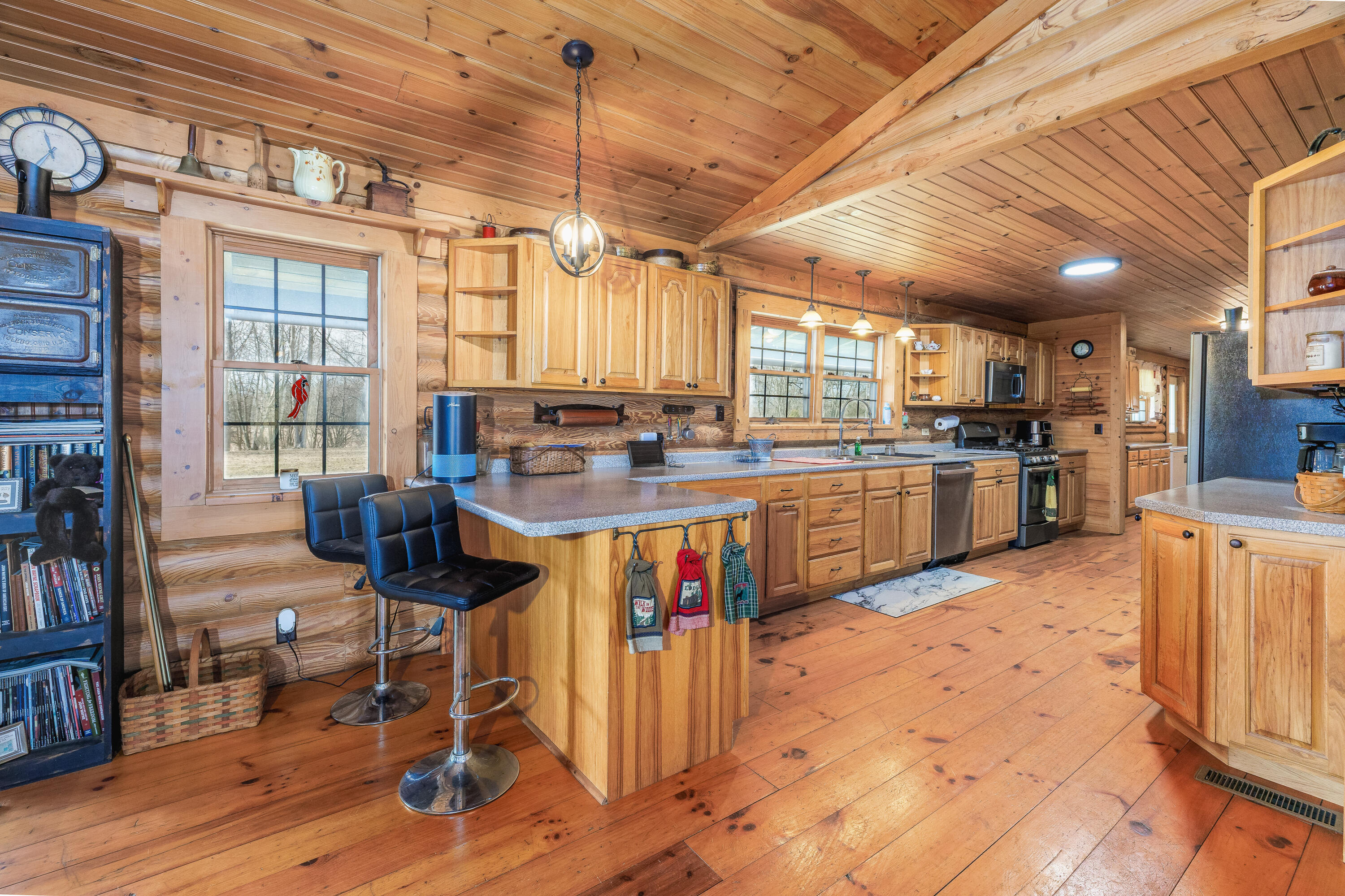 7523 West 850th Street South Rensselaer, IN 47978 - Photo 26 of 39 a open kitchen with stainless steel appliances granite countertop a stove top oven a refrigerator a dining table and chairs with wooden floor